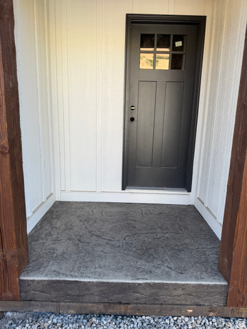 389 West 2100 South Perry, UT 84302 - Photo 6 of 21 Craftsman-style entry door with divided lites, board-and-batten siding, and a textured concrete entry pad