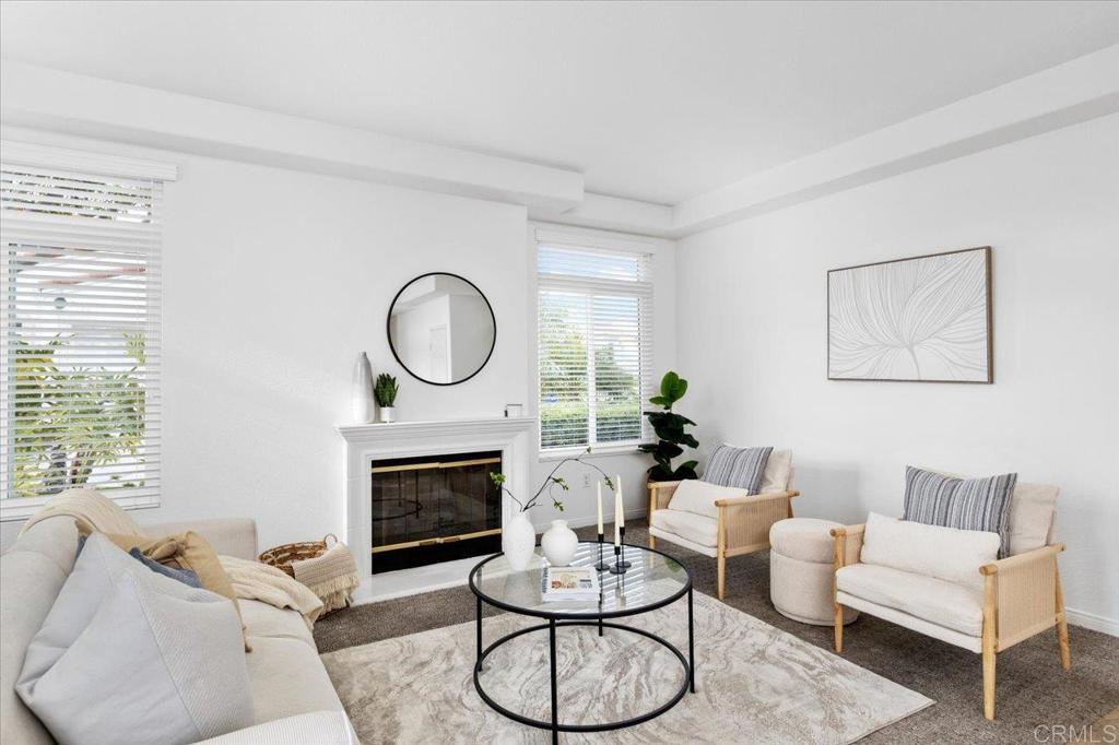 3315 Genoa Way, Unit 96 Oceanside, CA 92056 - Photo 1 of 1 a living room with furniture a window and a fireplace