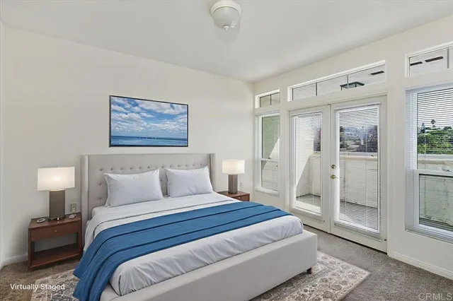 a bedroom with a bed and glass door