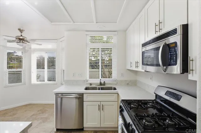 a kitchen with stainless steel appliances a sink stove and cabinets