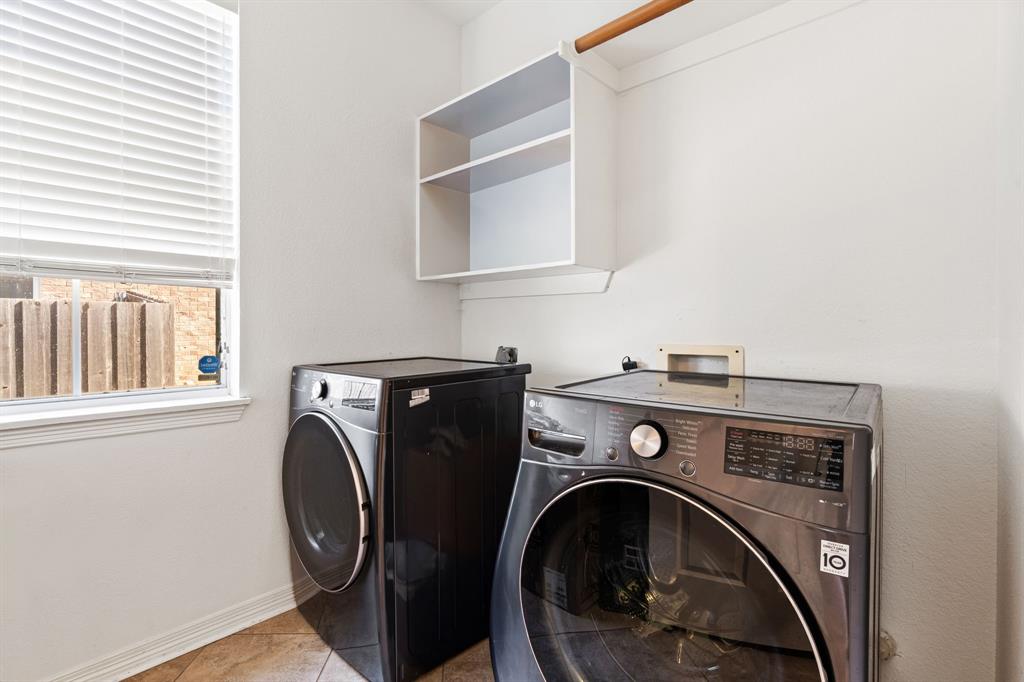 3905 Lakeside Drive Rowlett, TX 75088 - Photo 20 of 39 Laundry room with washing machine and clothes dryer and baseboards