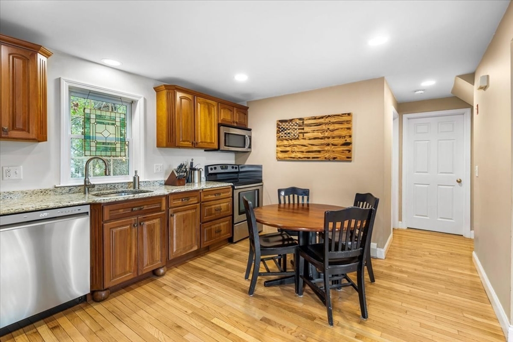20 Cooks Lane Bellingham, MA 02019 - Photo 10 of 21 a kitchen with granite countertop a sink cabinets and wooden floor