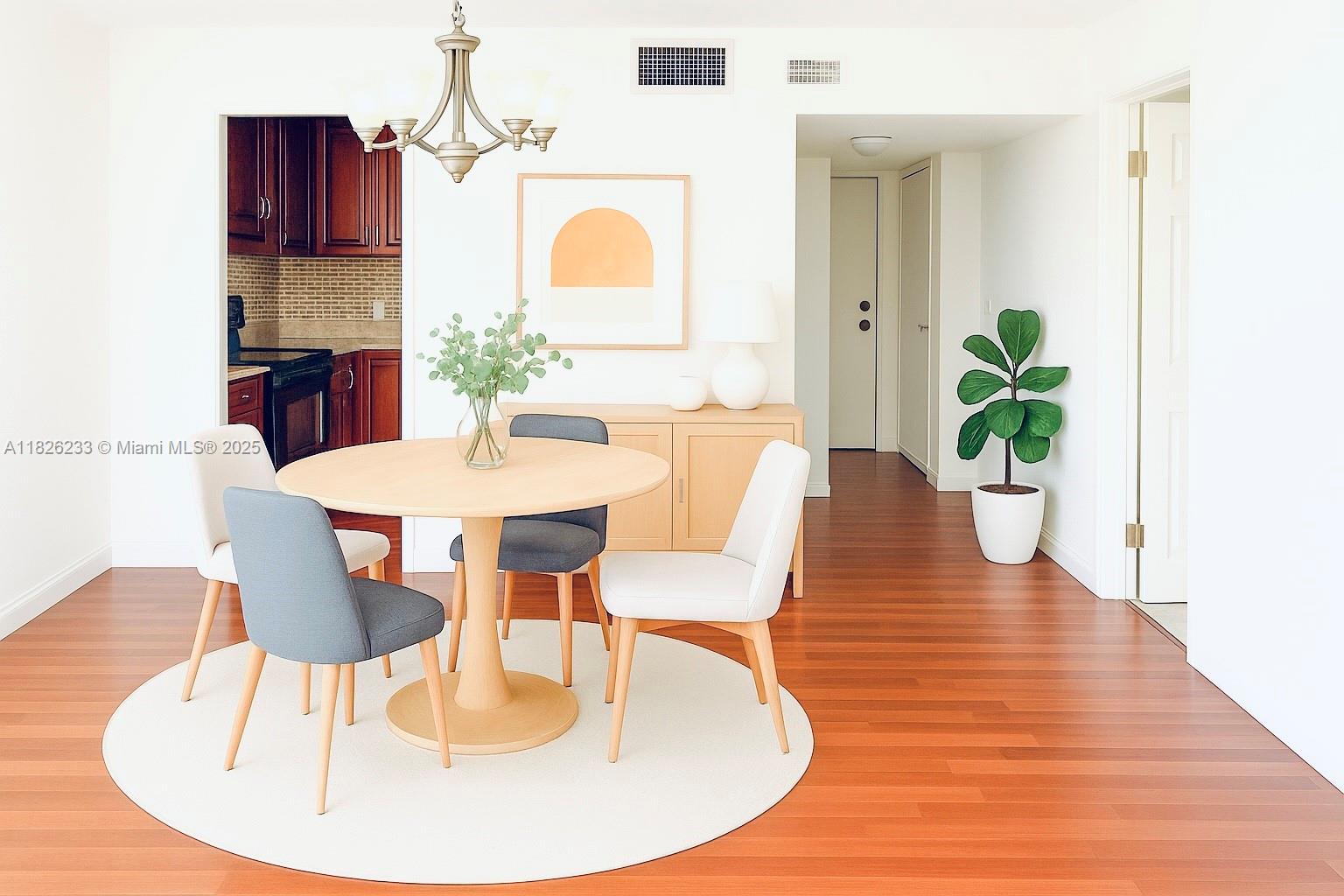 2025 Northeast 164th Street, Unit 901 North Miami Beach, FL 33162 - Photo 5 of 12 a dining room with furniture and wooden floor