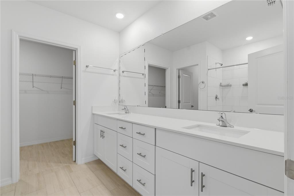 2455 Lanier Road Zephyrhills, FL 33541 - Photo 19 of 39 a bathroom with double sink and a mirror