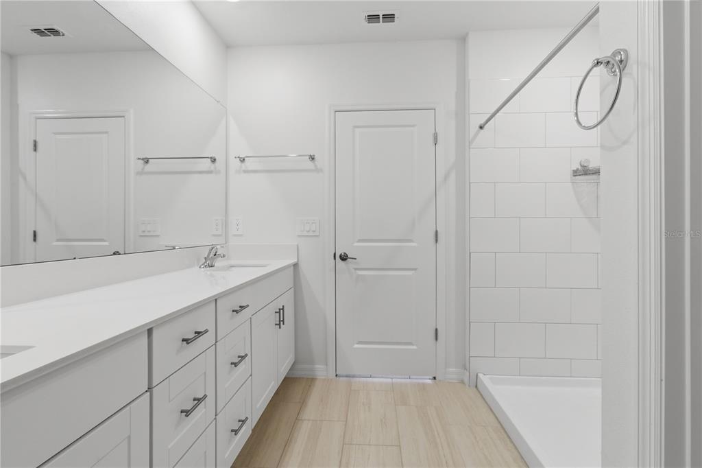 2455 Lanier Road Zephyrhills, FL 33541 - Photo 20 of 39 a bathroom with a double vanity sink and mirror