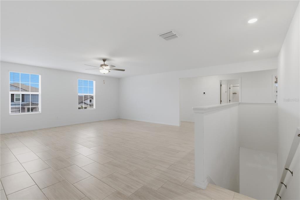 2455 Lanier Road Zephyrhills, FL 33541 - Photo 22 of 39 an empty room with windows and entrance