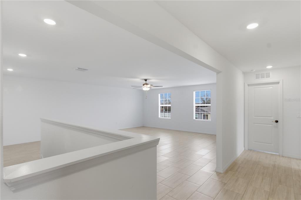 2455 Lanier Road Zephyrhills, FL 33541 - Photo 23 of 39 wooden floor in an empty room with a window
