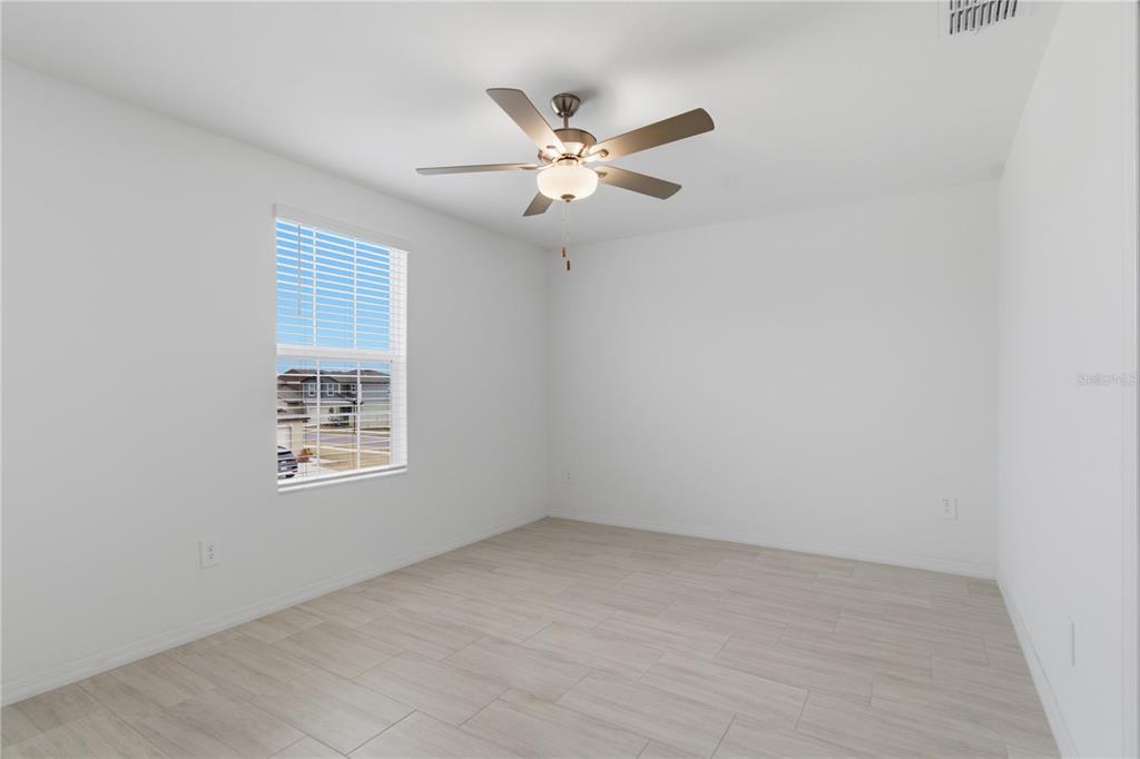 2455 Lanier Road Zephyrhills, FL 33541 - Photo 24 of 39 an empty room with a window and a ceiling fan