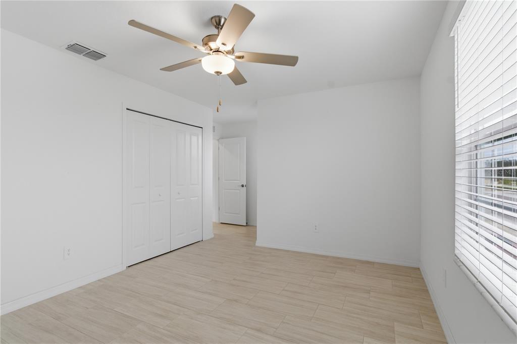 2455 Lanier Road Zephyrhills, FL 33541 - Photo 25 of 39 wooden floor in an empty room with a window