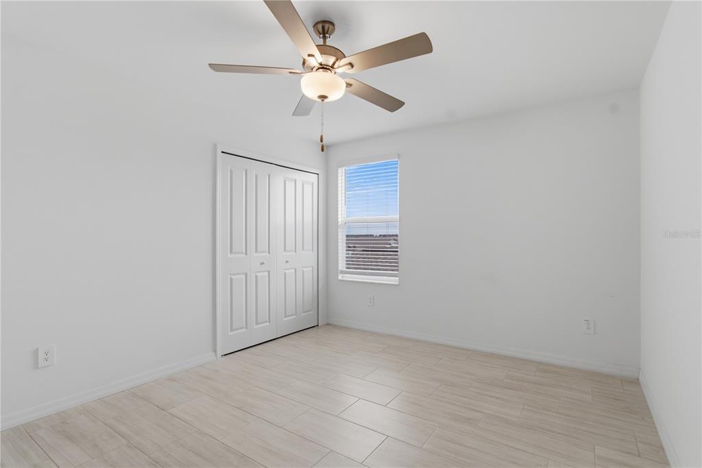 2455 Lanier Road Zephyrhills, FL 33541 - Photo 27 of 39 an empty room with fan and windows