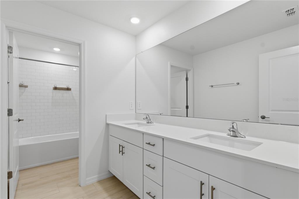 2455 Lanier Road Zephyrhills, FL 33541 - Photo 28 of 39 a bathroom with a granite countertop sink mirror and double