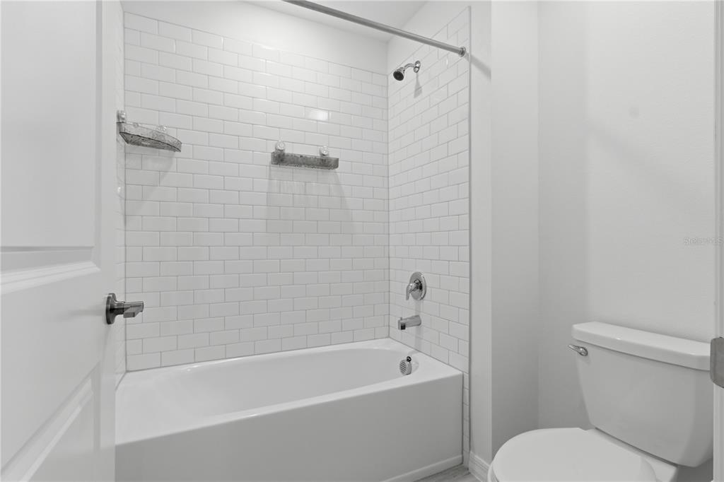 2455 Lanier Road Zephyrhills, FL 33541 - Photo 29 of 39 a white bath tub sitting next to a toilet