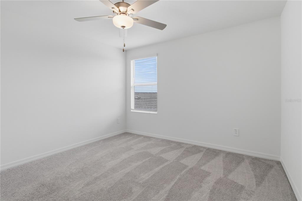 2455 Lanier Road Zephyrhills, FL 33541 - Photo 31 of 39 en empty room with a window and a fan