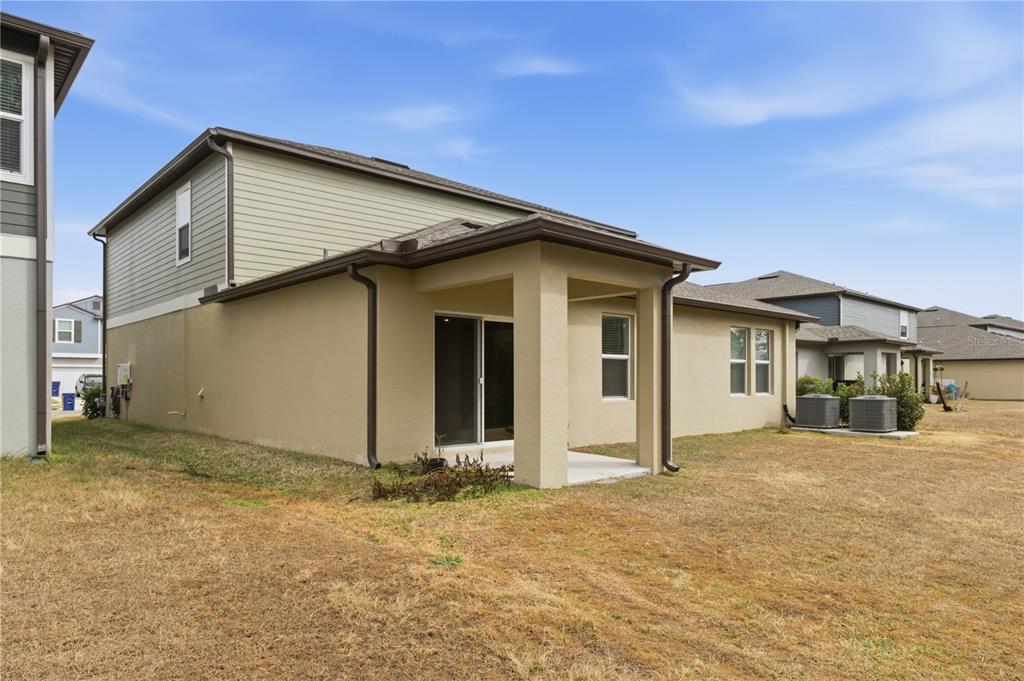 2455 Lanier Road Zephyrhills, FL 33541 - Photo 34 of 39 a front view of a house with a yard