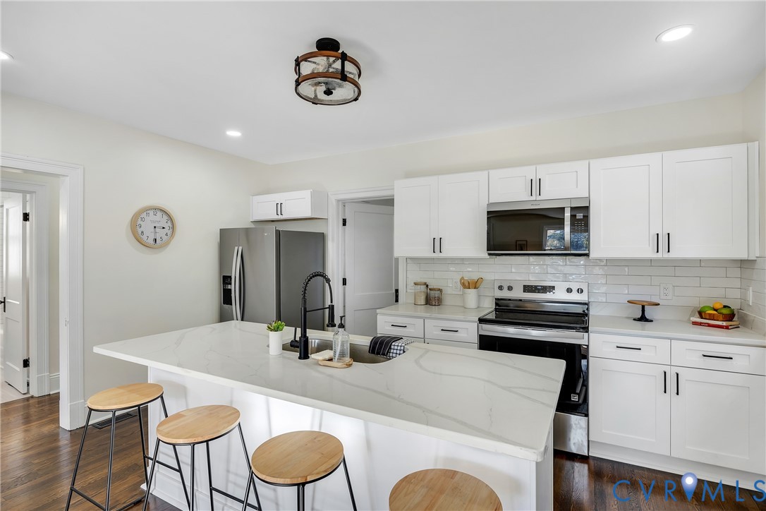 7232 Edgeworth Road Mechanicsville, VA 23111 - Photo 10 of 31 Kitchen with stainless steel appliances, backsplas