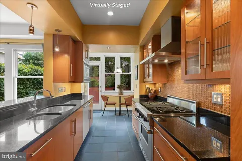 a kitchen with stainless steel appliances granite countertop a stove and a refrigerator