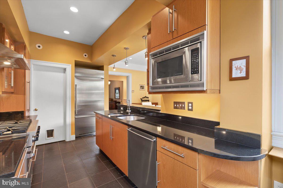 2816 27th Street Northwest Washington, DC 20008 - Photo 17 of 71 a kitchen with stainless steel appliances granite countertop a sink and a stove