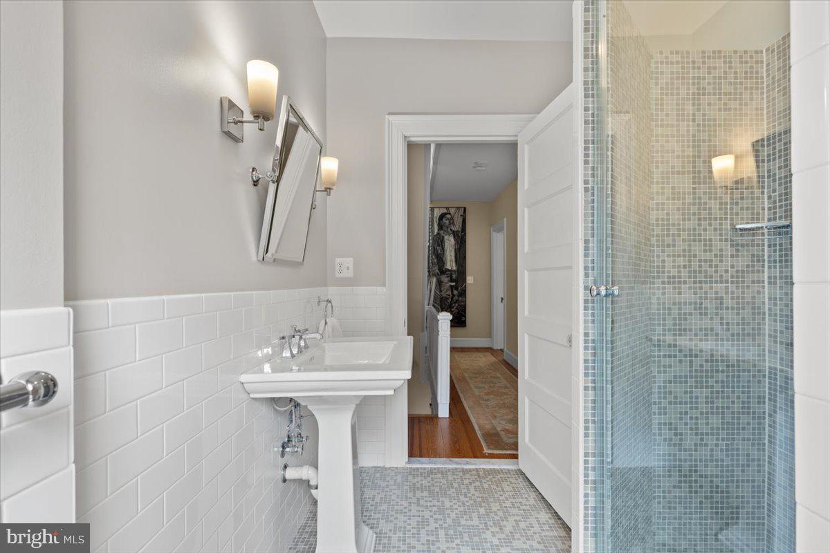 2816 27th Street Northwest Washington, DC 20008 - Photo 23 of 71 a bathroom with a sink a mirror and shower