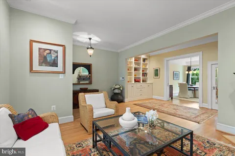 a dining room with furniture a chandelier and wooden floor
