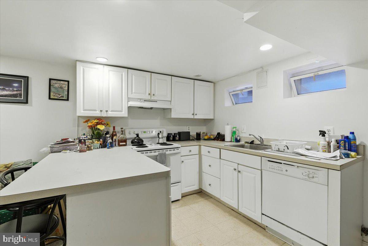 2816 27th Street Northwest Washington, DC 20008 - Photo 57 of 71 a kitchen with a sink a stove and cabinets