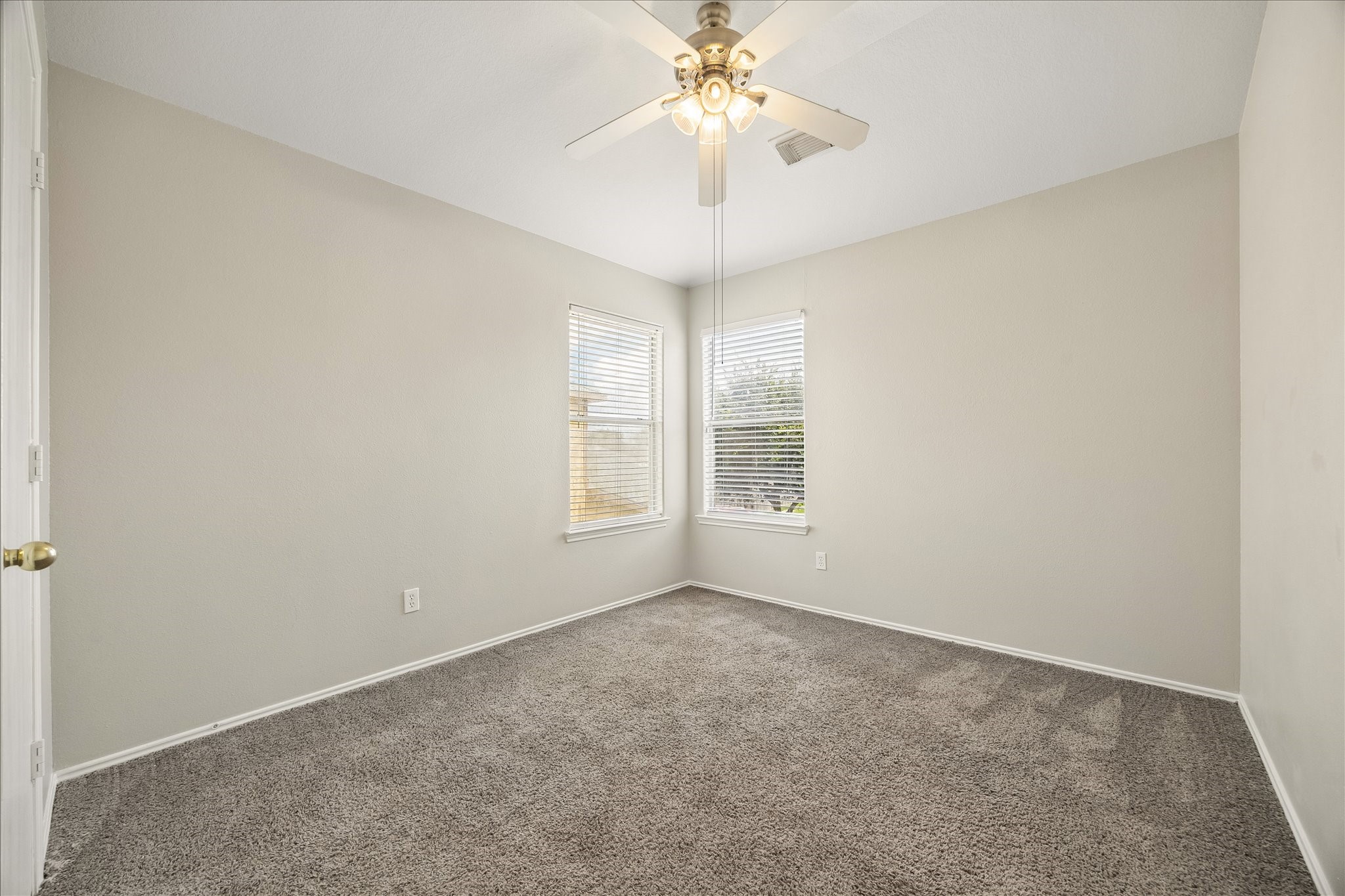 223 Sunset Colony Drive Rosharon, TX 77583 - Photo 33 of 50 Rounding out the bedrooms upstairs, this spacious guest room keeps things fresh and comfortable with soft neutral finishes, plush carpet, a cooling ceiling fan and natural light from corner windows.