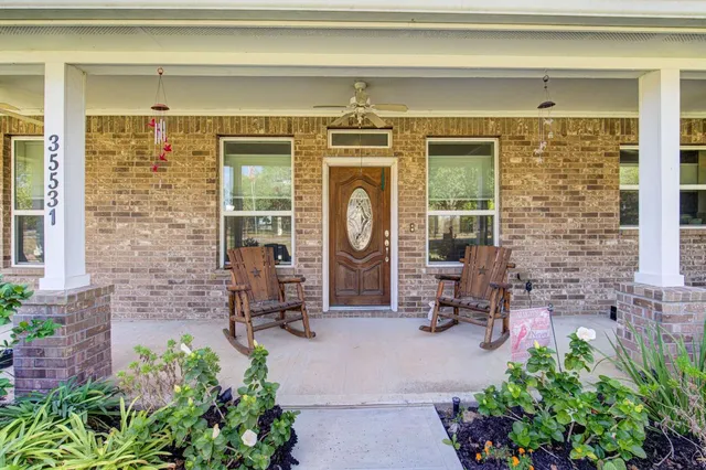 a living room filled with furniture and a potted plant