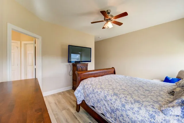 a bedroom with a bed and a chandelier
