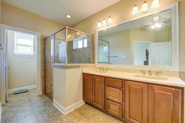 a bathroom with a double vanity sink and mirror