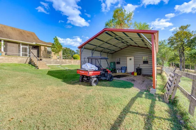 a house view with swimming pool and trees in the background