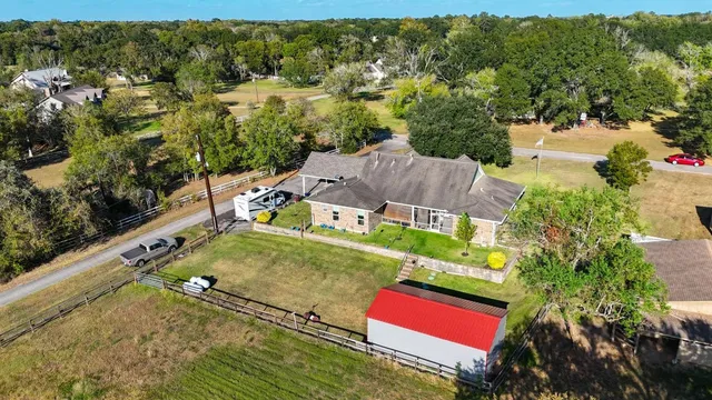 an aerial view of a house with a garden and fire pit