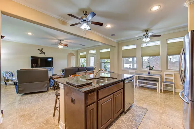 a kitchen with a stove a sink a dining table and chairs