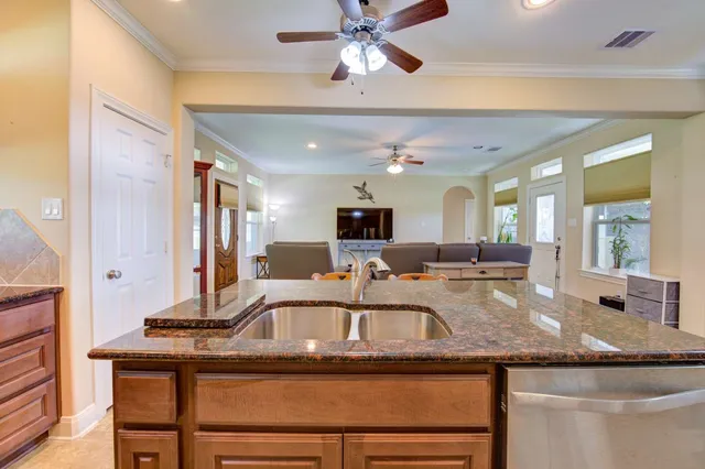 a kitchen with a sink a counter space and dining table