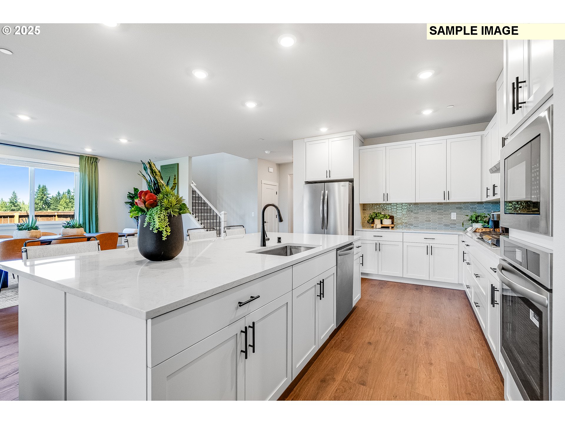 2650 South 4th Way Ridgefield, WA 98642 - Photo 7 of 43 a kitchen with counter top space a sink stainless steel appliances and cabinets