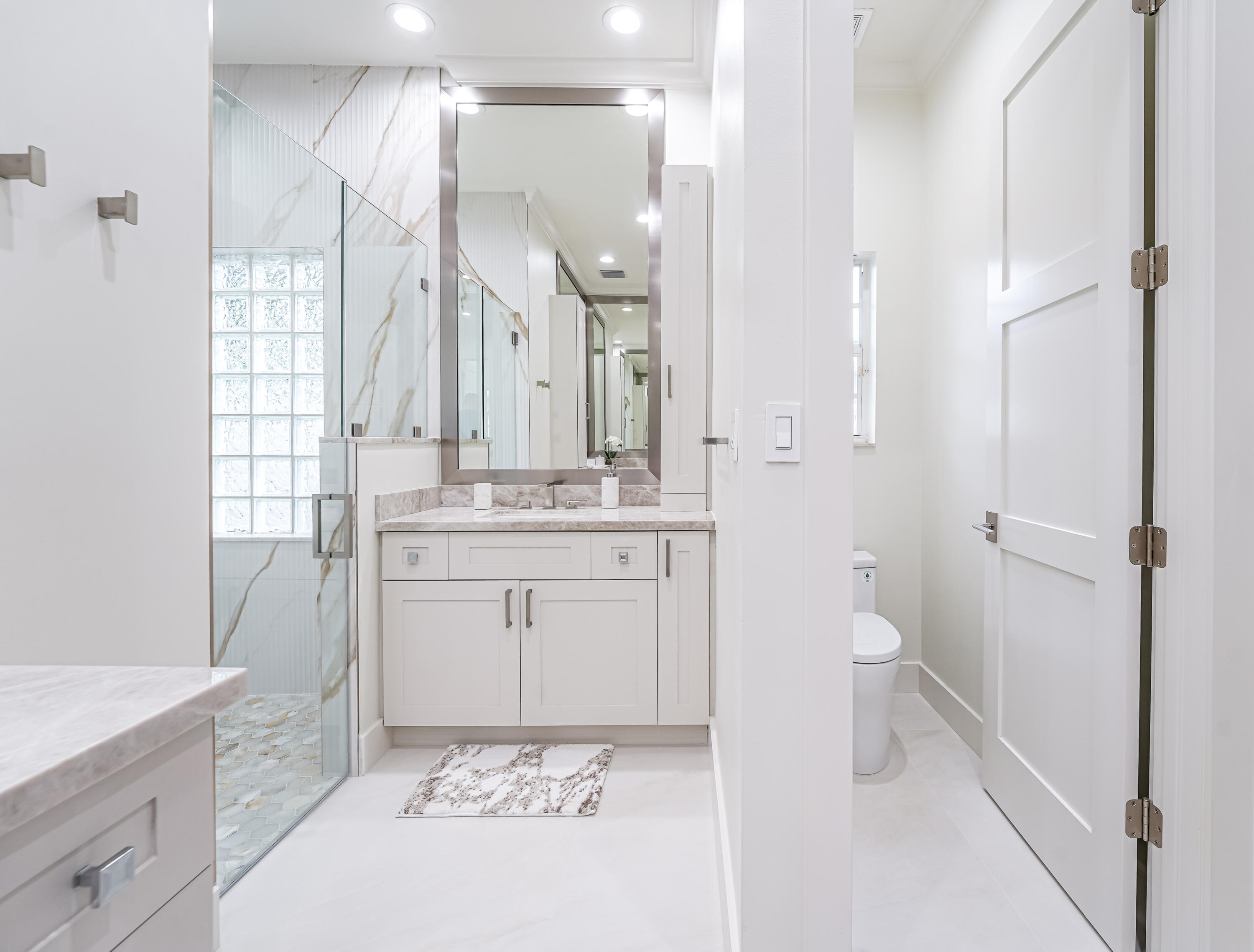 749 Northeast 71st Street Boca Raton, FL 33487 - Photo 20 of 43 a bathroom with a sink a toilet and a large mirror