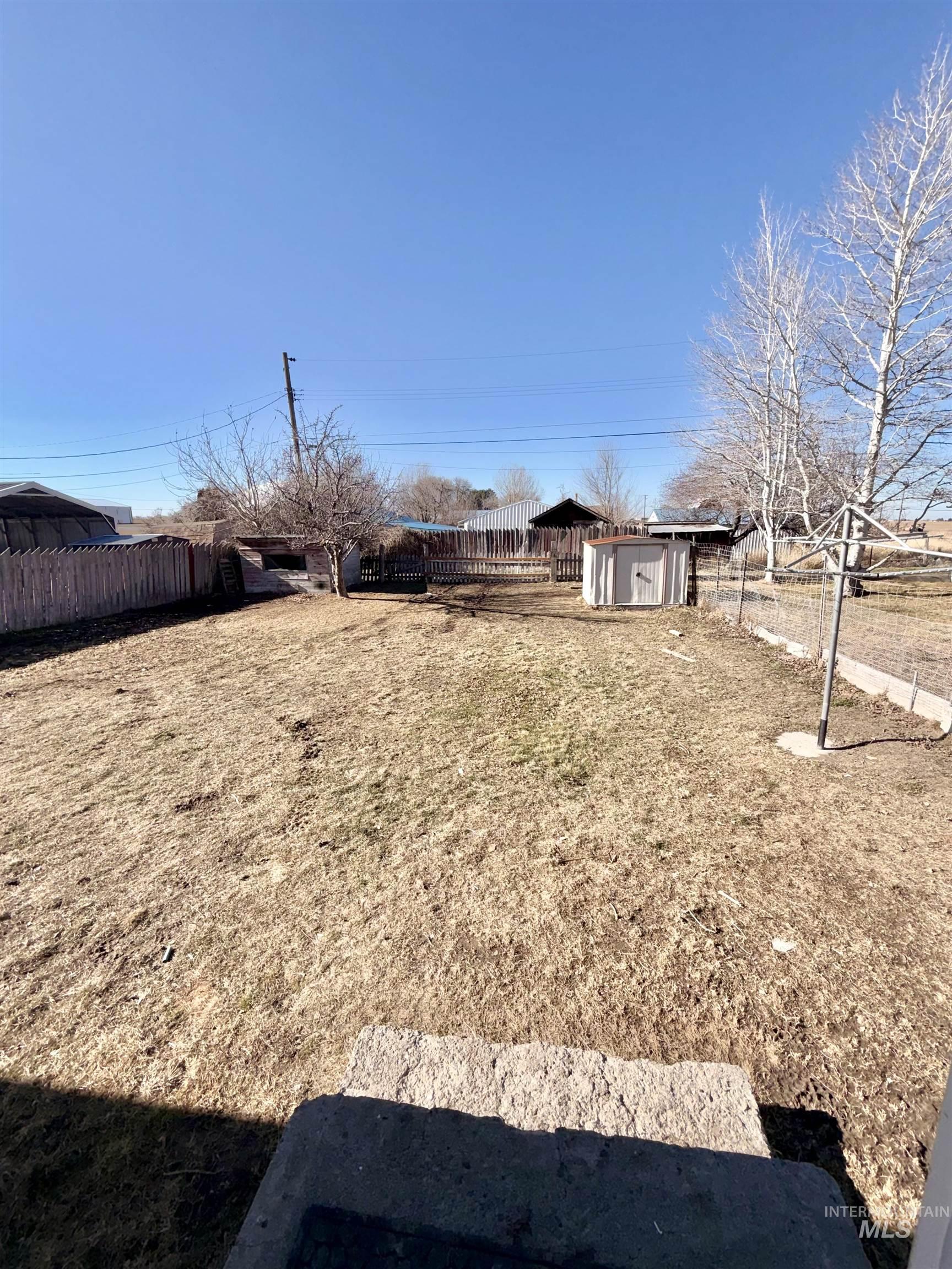478 2nd Street West Hansen, ID 83334 - Photo 15 of 15 Fenced backyard featuring a storage unit