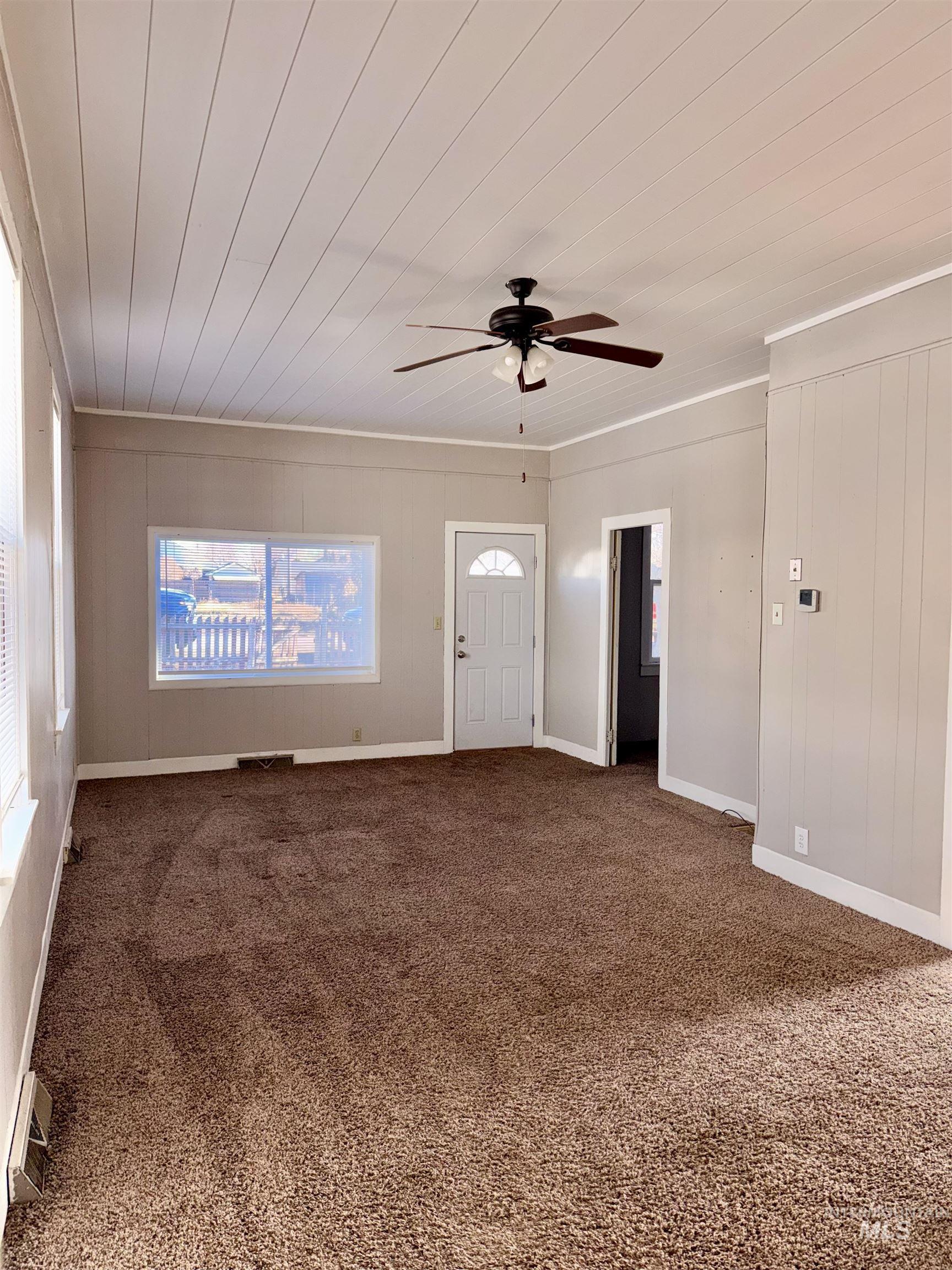 478 2nd Street West Hansen, ID 83334 - Photo 3 of 15 Entryway featuring ceiling fan, dark colored carpet, wood ceiling, and crown molding