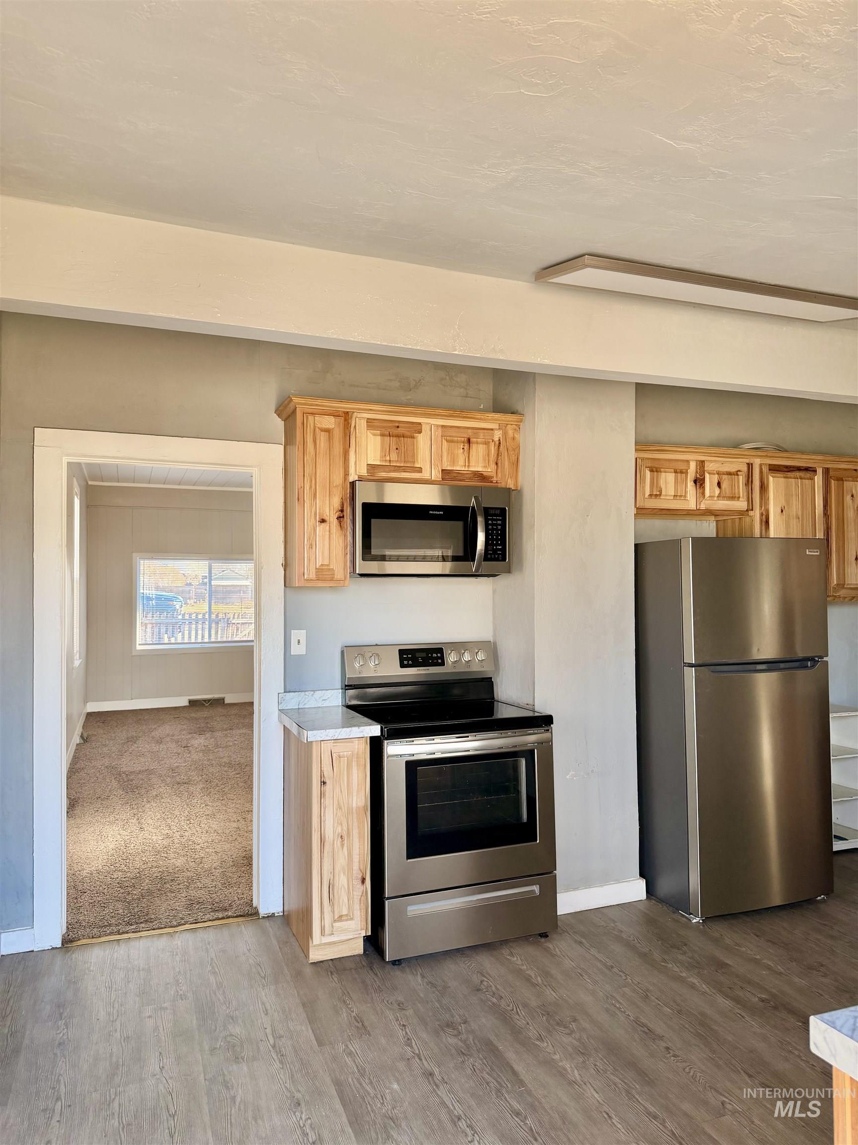 478 2nd Street West Hansen, ID 83334 - Photo 7 of 15 Kitchen featuring stainless steel appliances, light countertops, light wood finished floors, and light wood finish cabinetry