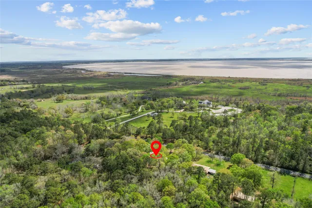 a bedroom with a bed and a flat tv screen on the dresser