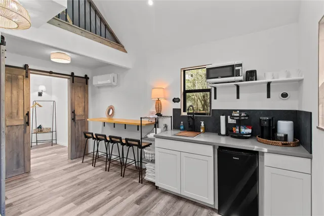 a kitchen with a sink cabinets and wooden floor