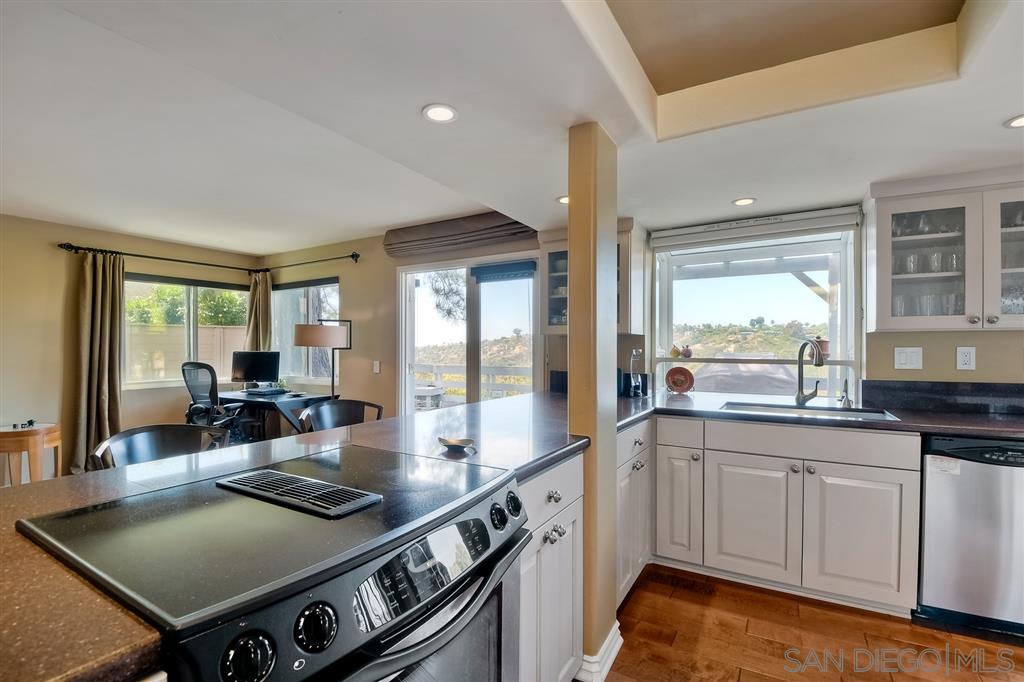 3622 Garner Place Encinitas, CA 92024 - Photo 14 of 25 a kitchen with a stove and white cabinets