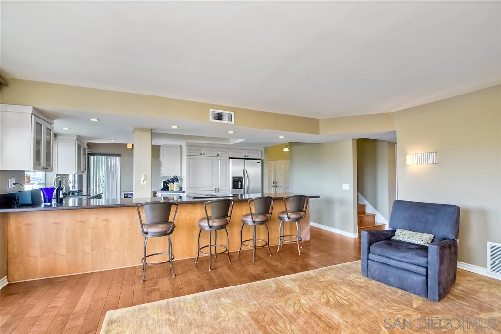 3622 Garner Place Encinitas, CA 92024 - Photo 17 of 25 a living room with furniture a wooden floor and kitchen view