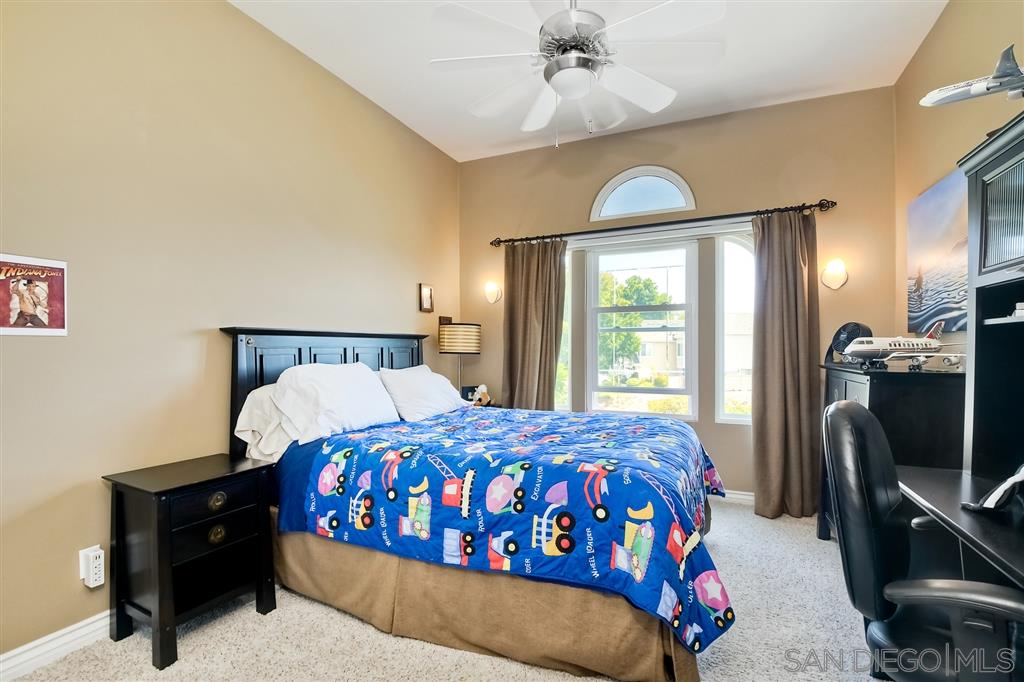 3622 Garner Place Encinitas, CA 92024 - Photo 18 of 25 a bedroom with a bed mirror and window