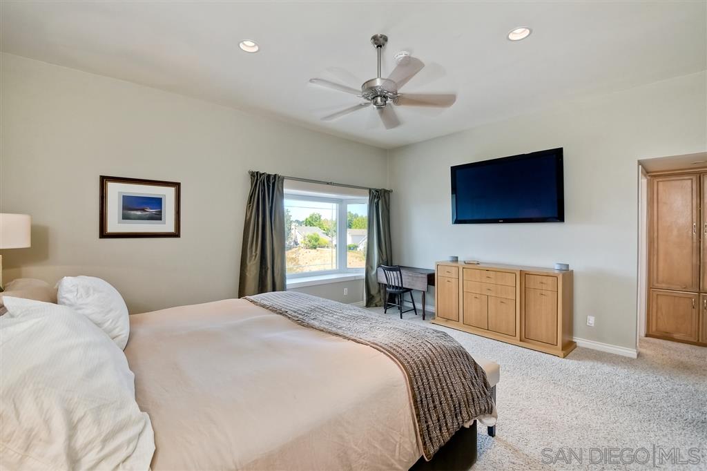3622 Garner Place Encinitas, CA 92024 - Photo 20 of 25 a bedroom with a bed and a flat screen tv