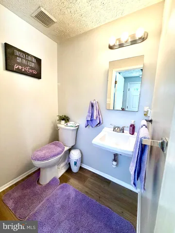 a bathroom with a sink mirror and toilet
