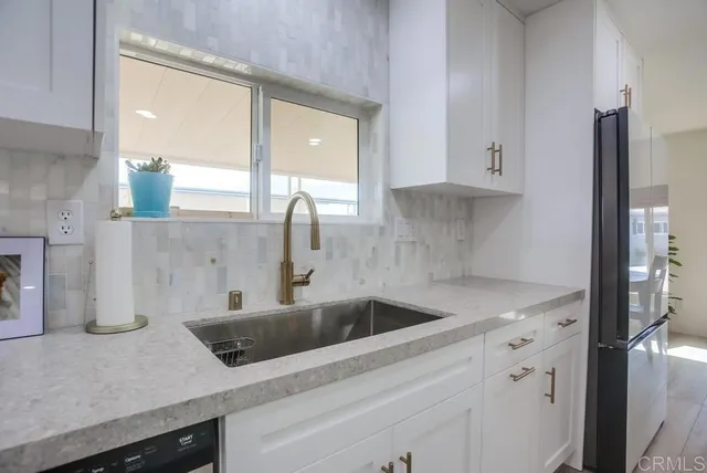 a kitchen with a sink and cabinets