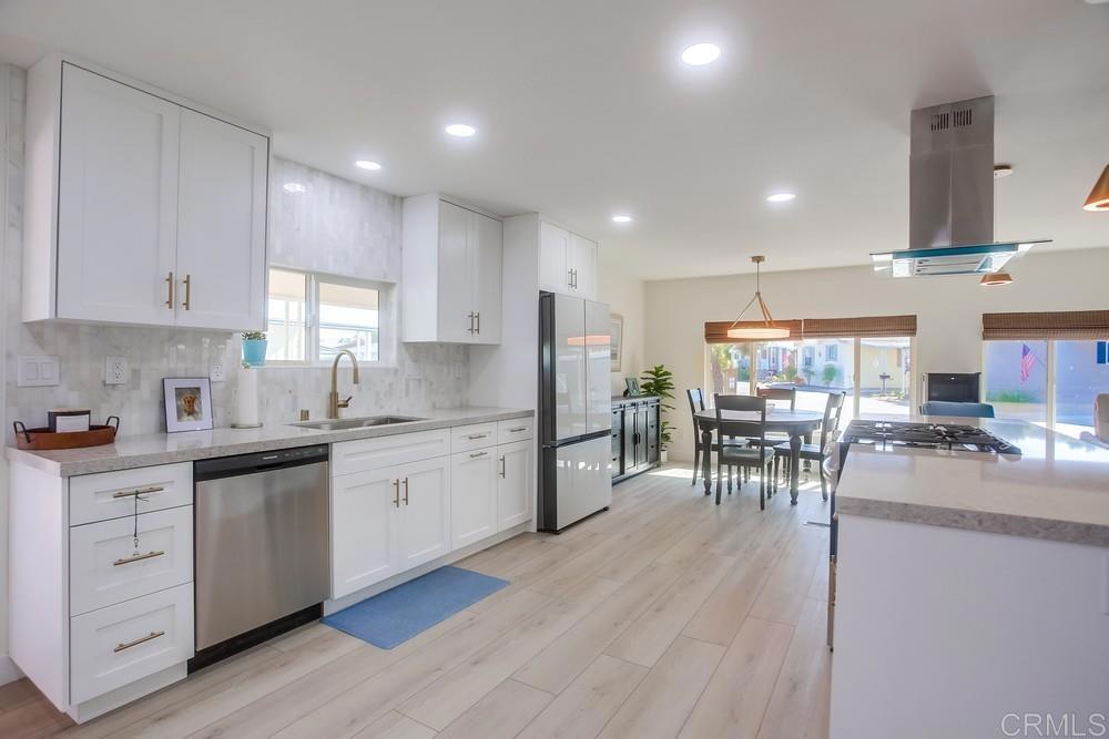 8301 Mission Gorge Road Santee, CA 92071 - Photo 14 of 35 a kitchen with white cabinets and chairs