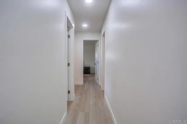 a view of a room with wooden floor
