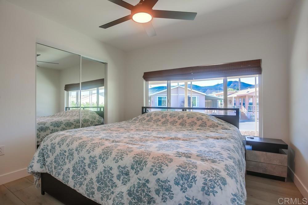 8301 Mission Gorge Road Santee, CA 92071 - Photo 16 of 35 a bed sitting in a spacious bedroom next to a window