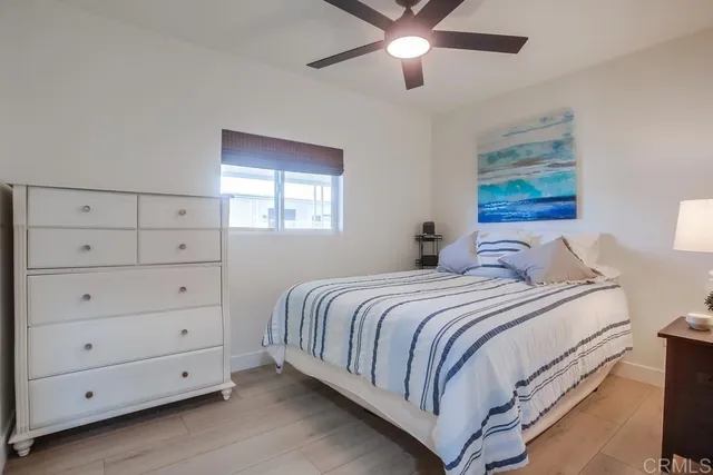 a bedroom with a large bed and a window