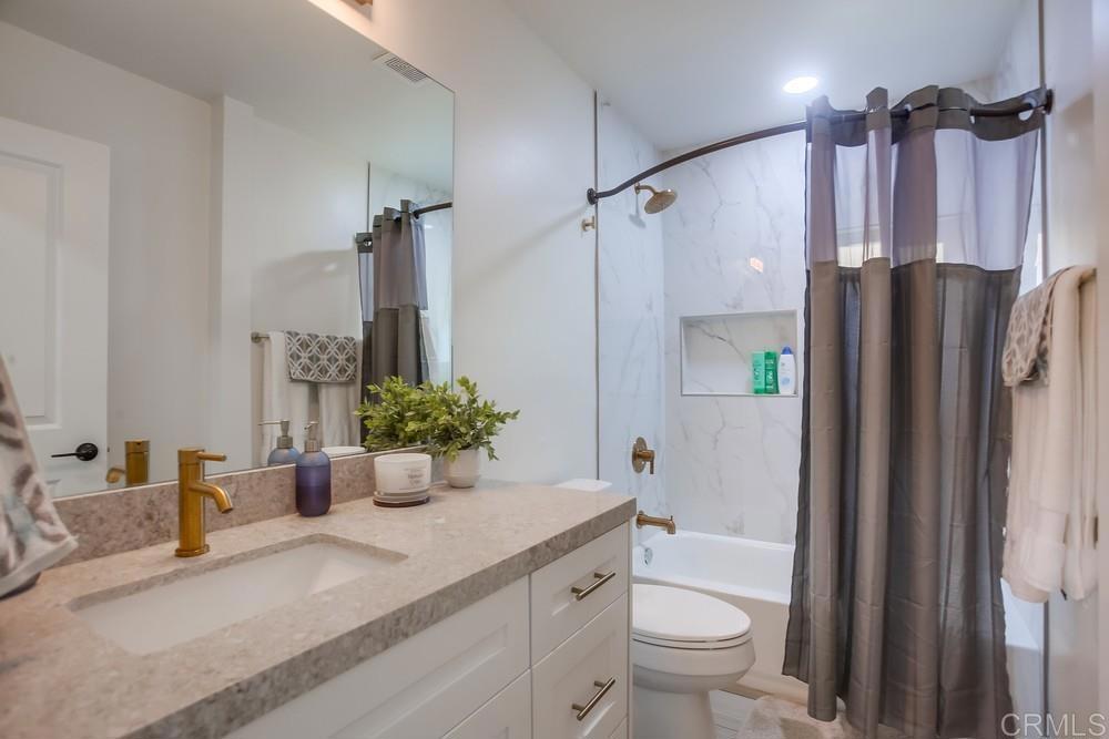 8301 Mission Gorge Road Santee, CA 92071 - Photo 24 of 35 a bathroom with a granite countertop sink toilet and shower